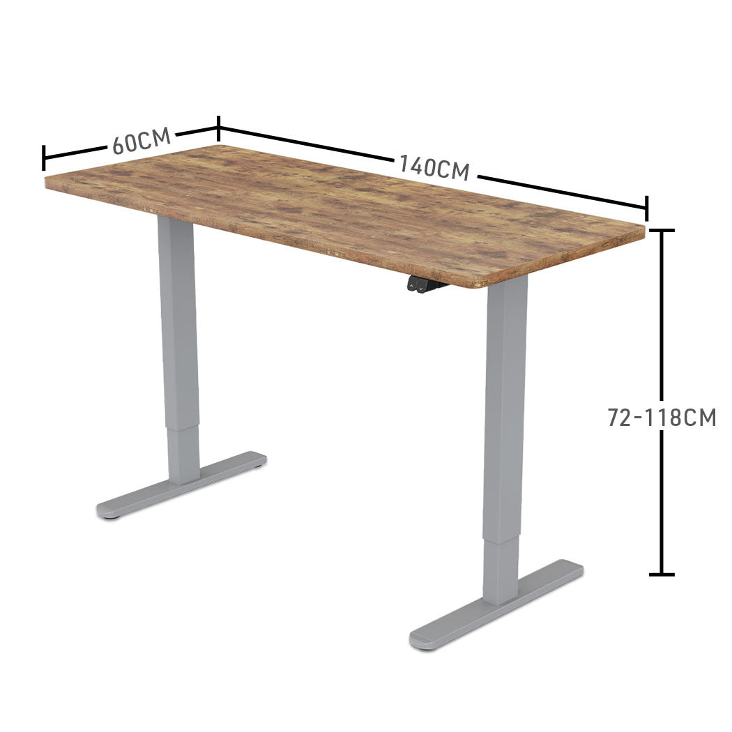 Fortia Sit To Stand Up Standing Desk, 140x60cm, 72-118cm Electric Height Adjustable, 70kg Load, Oak Style/Silver Frame